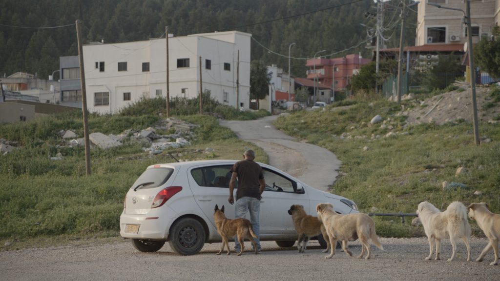 "Zeidan and dogs", film still, Jumana Manna, Foragers, 2022