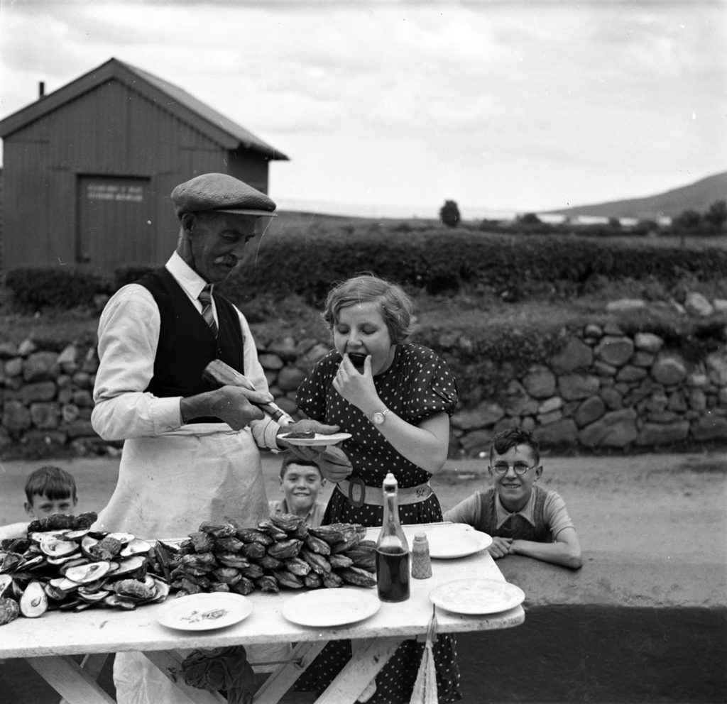 "Peter McKevitt, oyster vendor", Carlingford, County Louth, c. 1950. Photo: Maurice Curtin, by Dúchas © National Folklore Collection UCD.