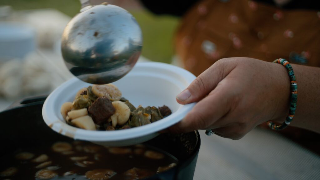 a ladle spooning food into a bowl