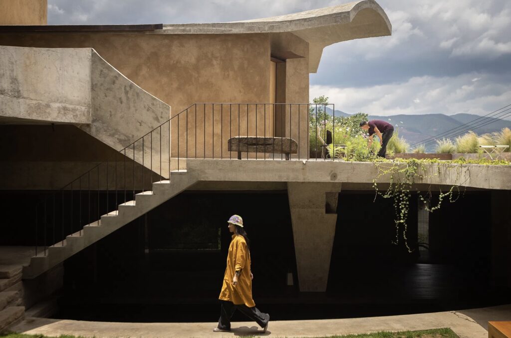 A woman walking in front of a modern building in Yunnan