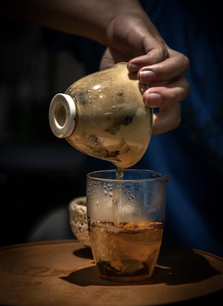 Pouring tea into a cup in Yunnan